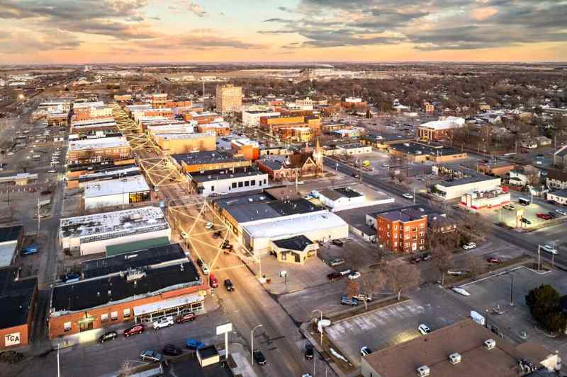 Aerial view of downtown cityscape at sunset with buildings.